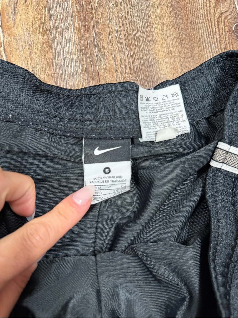 Vintage y2k Nike black shorts with white stripes on sides and hem, size S